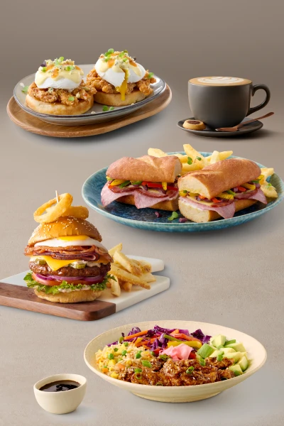 Eggs benedict, a deli sandwich, a stacked burger, an Asian rice bowl, and a cup of latte with latte art.